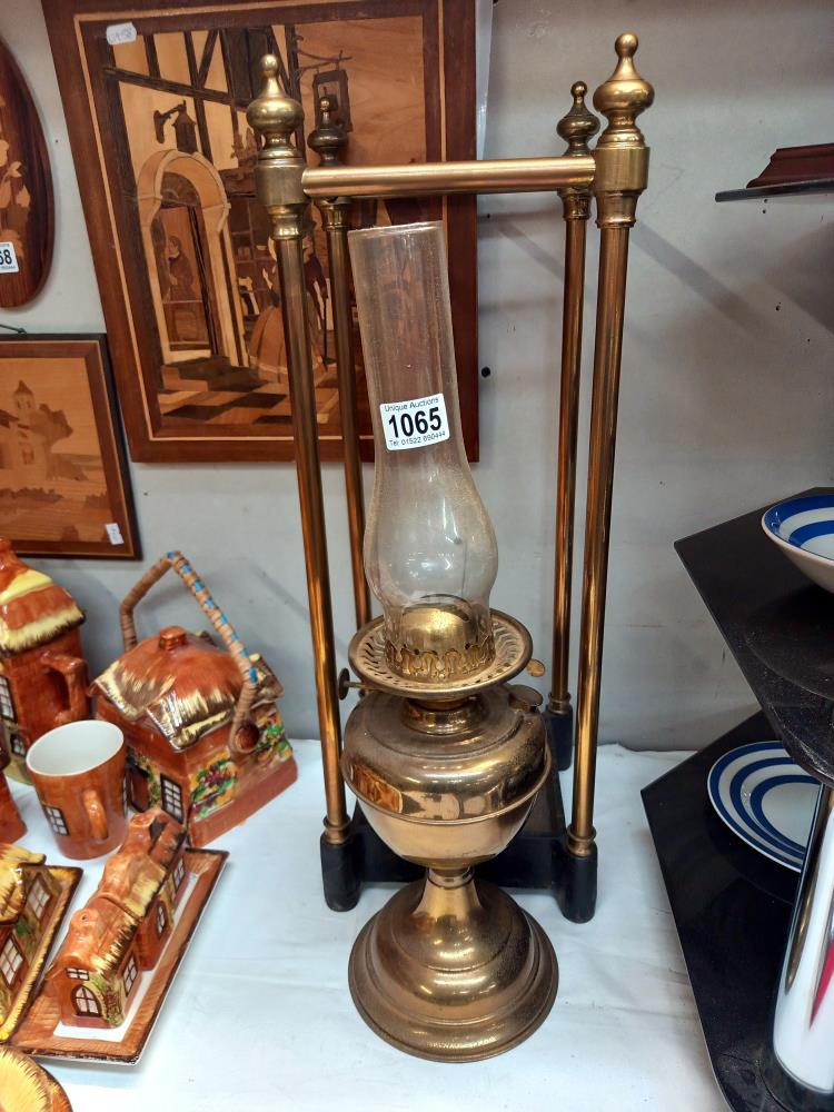 A brass stick/umbrella stand with cast iron base & an oil lamp COLLECT ONLY