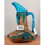 A late 19th/early 20th century, handblown glass wine jug, yellow ground with cobalt blue handle