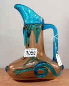 A late 19th/early 20th century, handblown glass wine jug, yellow ground with cobalt blue handle