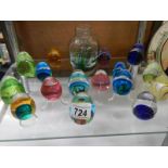 A quantity of glass paperweights and a vase.