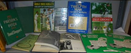 A quantity of cricket and football related books.