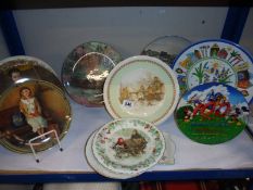A shelf of assorted collector's plates. COLLECT ONLY.