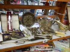 A mixed lot of silver plate including teapot, gravy boat, cutlery etc.,