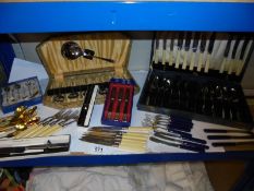 A shelf of assorted cutlery.
