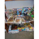 Two shelves of assorted comics and magazines.