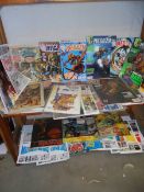 Two shelves of assorted comics and magazines.