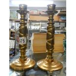 A pair of heavy brass candlesticks.