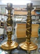A pair of heavy brass candlesticks.