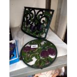 A cast iron book rest and teapot stand.