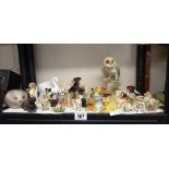 A shelf of dog and other animal figures.