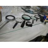 A quantity of magnifying glasses.