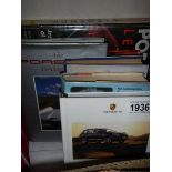 A Porsche Cayenne sales brochure/book and other Porsche related books.