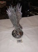 A large chrome eagle on radiator cap car mascot