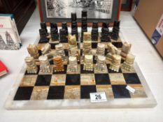 A mixed stone (including onyx) chess board with chess pieces