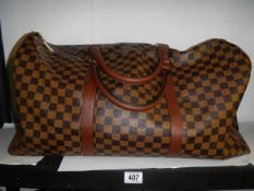 A Louis Viutton style holdall.