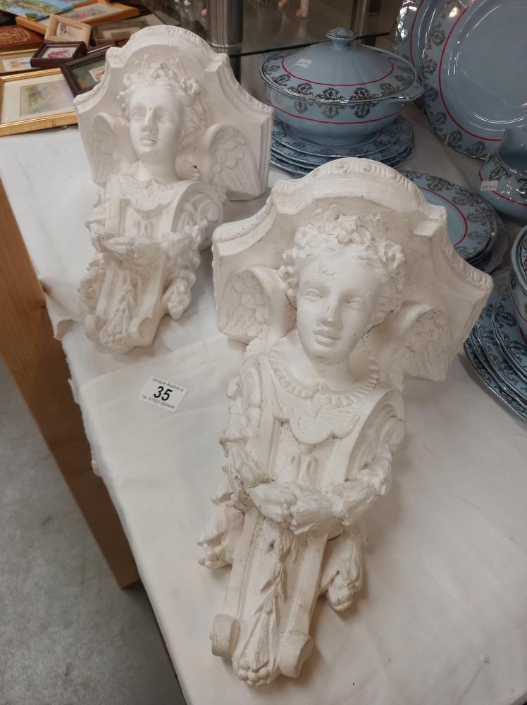 A pair of plaster figural wall bracket shelves COLLECT ONLY