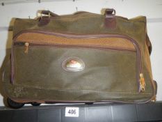 A Compass holdall with wheels.