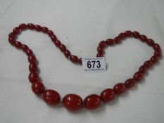 An amber coloured necklace.