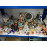 A mixed lot of dolls and toy figures.