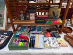 A quantity of games and home office items, cribbage board, dominoes, plus note books, envelopes,