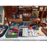 A quantity of games and home office items, cribbage board, dominoes, plus note books, envelopes,