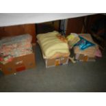 Three boxes of assorted curtains, blankets, bed linen etc.,