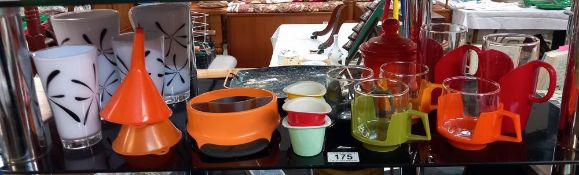 A shelf of retro/vintage plastic & glass cups & other items