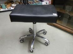 An adjustable stool on casters. COLLECT ONLY.