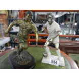 Two footballer figures in resin.