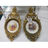 An excellent pair of brass framed china plates.