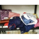 A mixed lot of new clothing including jumpers.