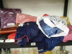 A mixed lot of new clothing including jumpers.