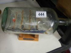 An early to mid 20th century old ship in a bottle.