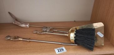 A quantity of fire irons with thistle decoration and a toasting fork with antler