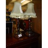 A pair of oak barley twist table lamps.