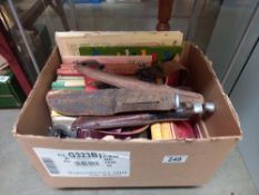 A box of vintage scouting books, badges, belt and knives
