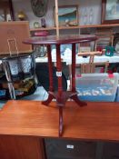 A dark wood stained triple pillared tripod wine table COLLECT ONLY