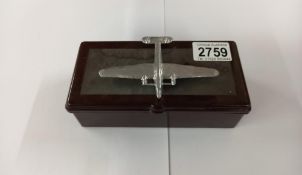 A vintage Bakelite cigarette box with surmounted white metal aeroplane and contents 17cm x 8.5cm x 6