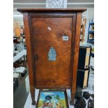 An Art Deco oak pot cupboard with chrome plated motifs on door Collect Only