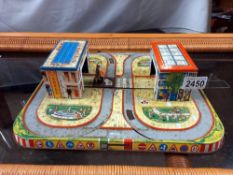 A vintage tin plate road way for clockwork cars