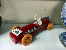 A cast iron Michelin man racing car in red