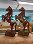 A pair of carved teak rearing horses Collect Only