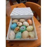 A box of polished stone egg hand coolers