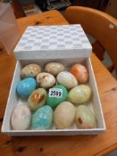 A box of polished stone egg hand coolers