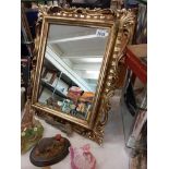 A gilt Ormolu framed mirror 44cm x 55cm. Collect only