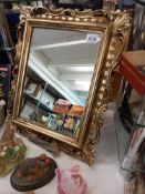 A gilt Ormolu framed mirror 44cm x 55cm. Collect only