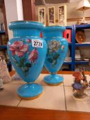 A pair of Victorian blue glass vases with overlaid painted flowers