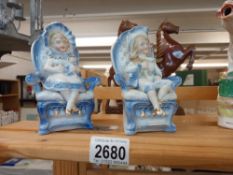 A pair of continental bisque seated figures Collect only