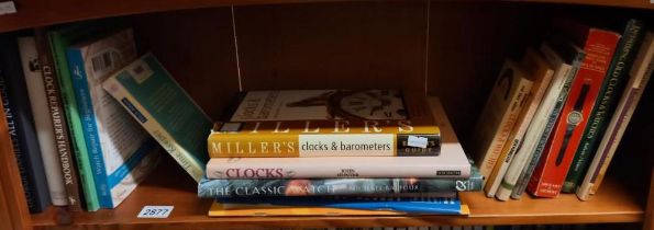 A shelf of books about clocks and repairing clocks collect only