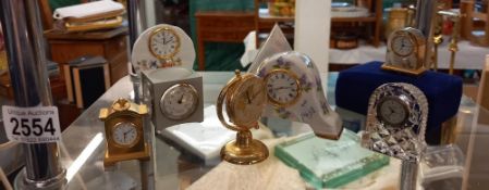 A selection of miniature decorative clocks including pewter, Edinburgh Crystal etc.